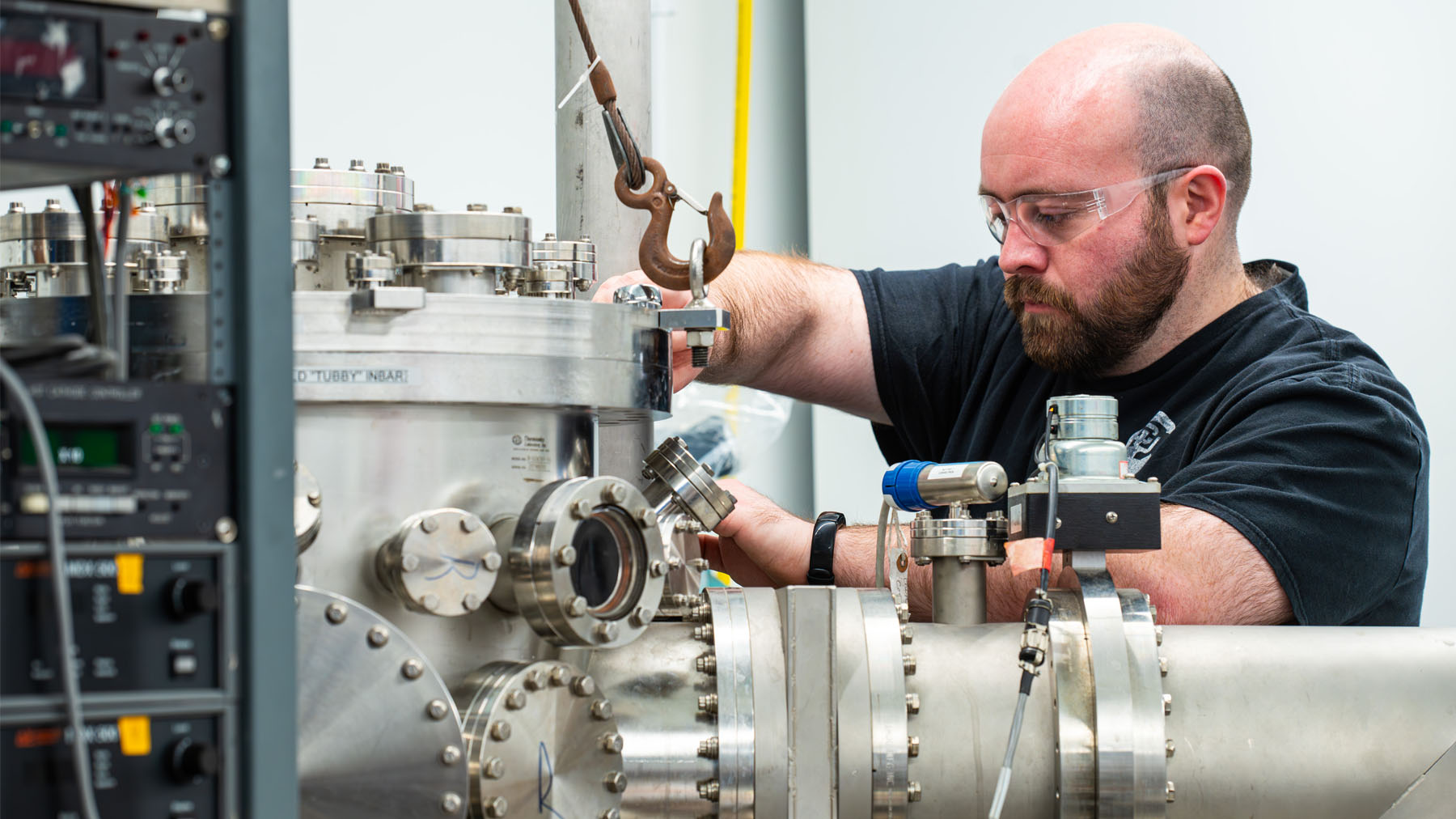 Zach Ulibarri working with equipment in a lab.